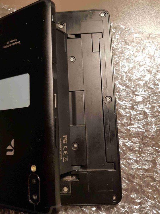 Remove these 5 screws; there is no need to remove the screw-protecting thingies, because there are no screws beneath them