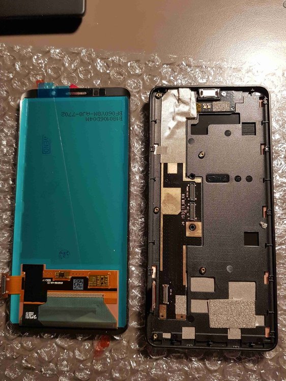 Screen and frame separated (display frame on the right laying on the front - so we are seeing the back)